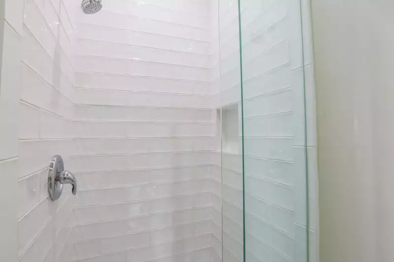 The en suite bathroom features a tiled, walk-in shower.