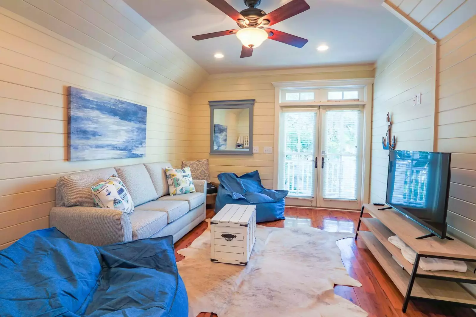 The game room has a large screen TV and a queen sofa bed.