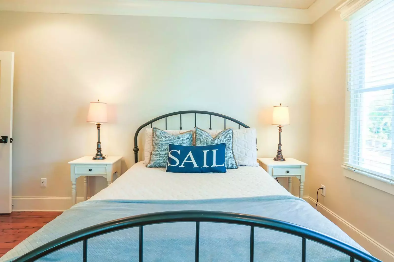 This guest bedroom has a queen bed, night stands with reading lamps and access to the back deck.