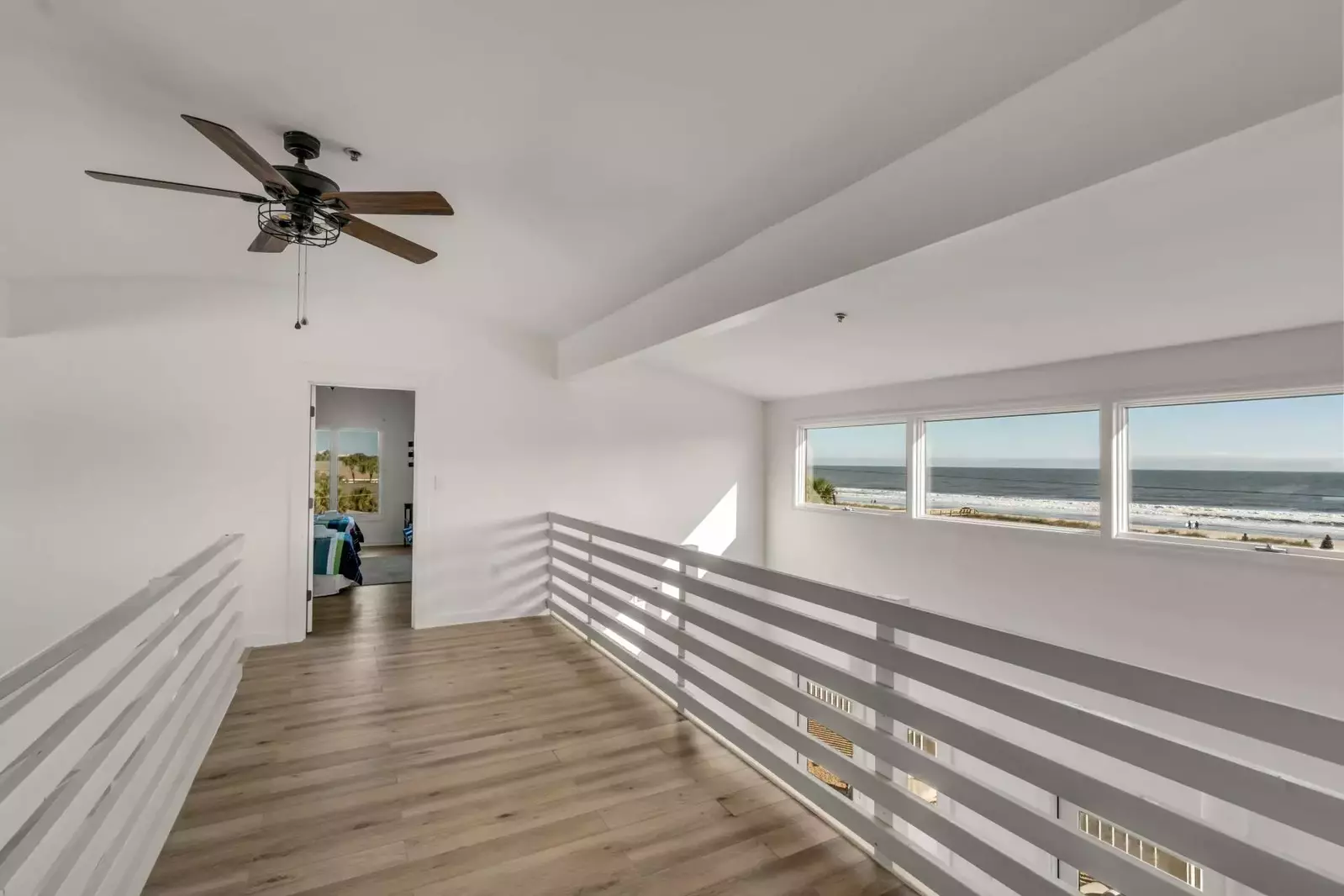 This walkway with stunning ocean views connects the two upstairs bedrooms.