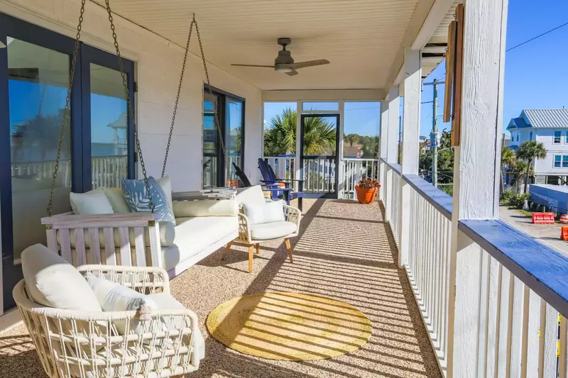There are multiple seating areas on the expansive covered balcony.