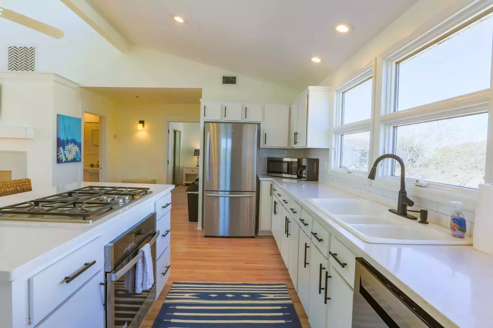 The kitchen features new quartz counters and stainless steel appliances.
