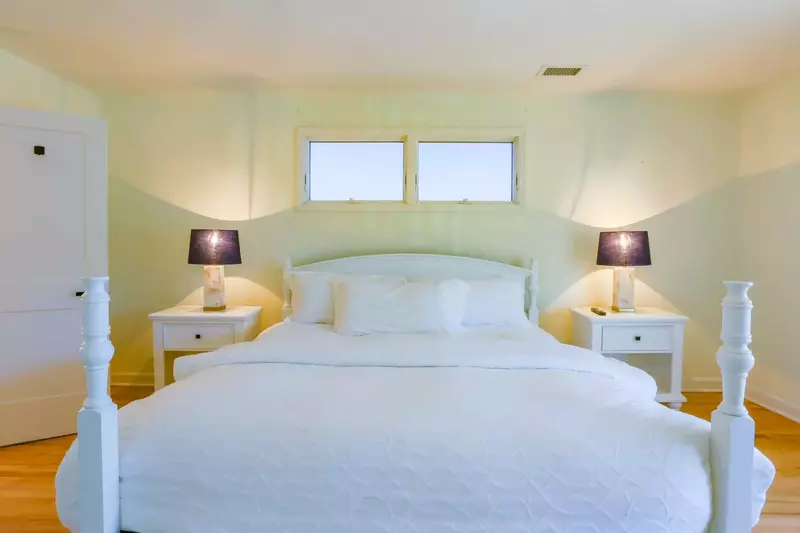 The master suite has a king bed and night stands with reading lamps.