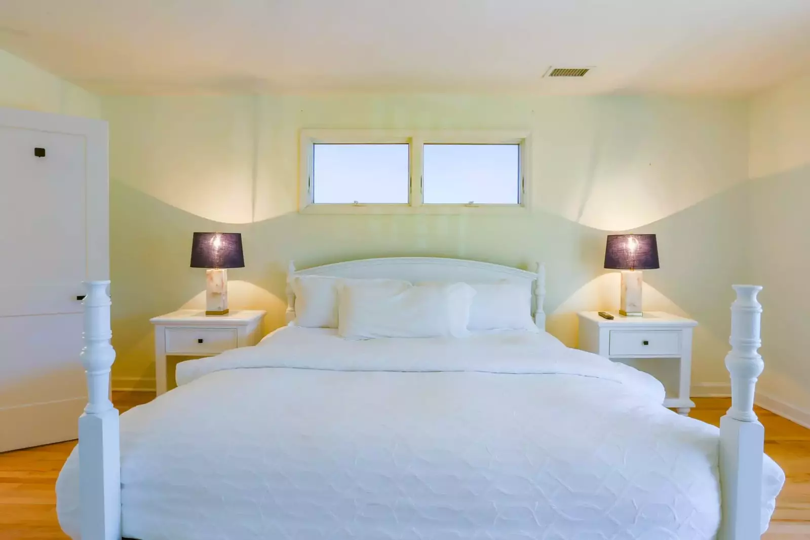 The master suite has a king bed and night stands with reading lamps.
