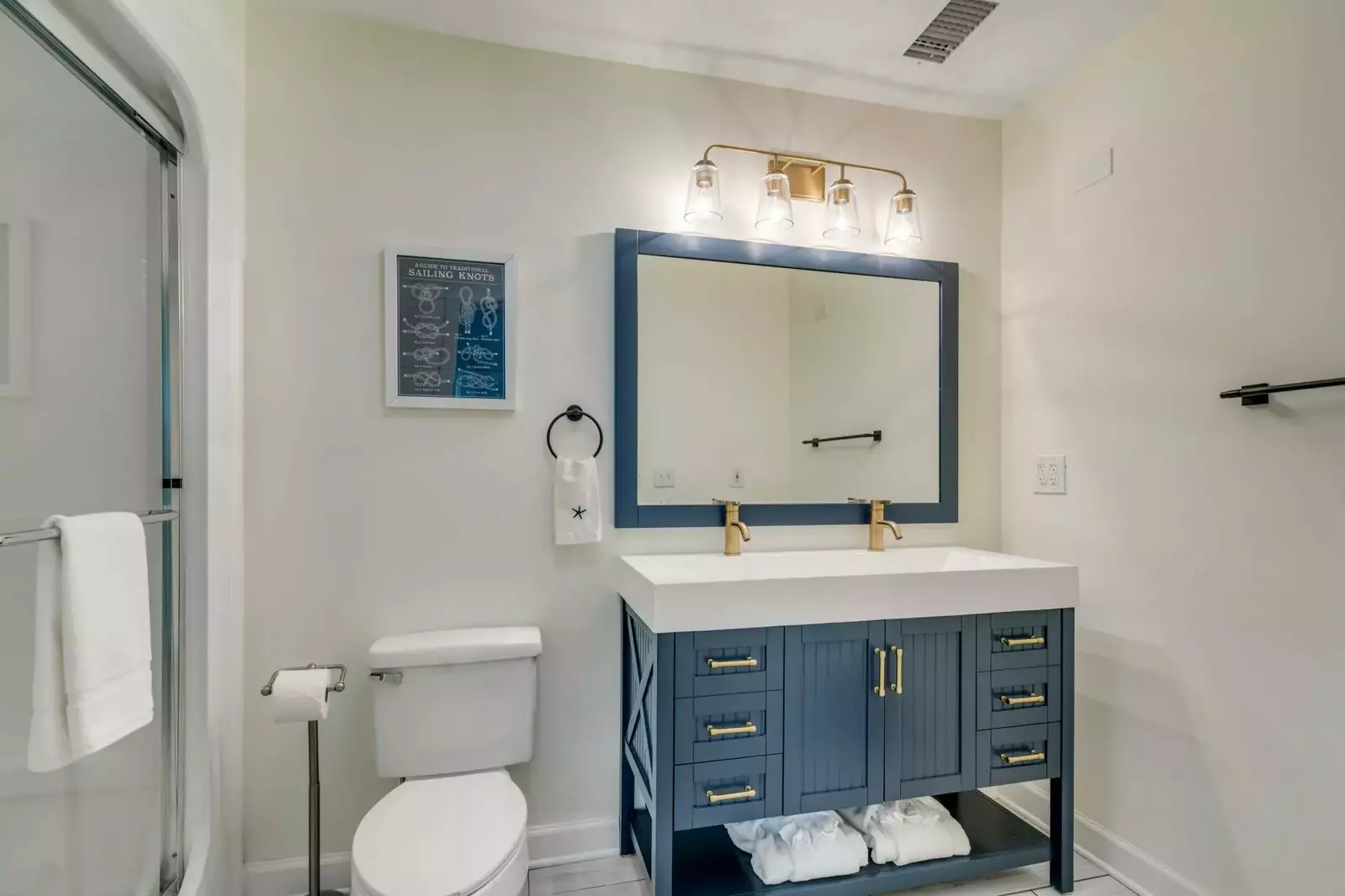 The master bathroom features a walk-in shower and double faucet vanity.