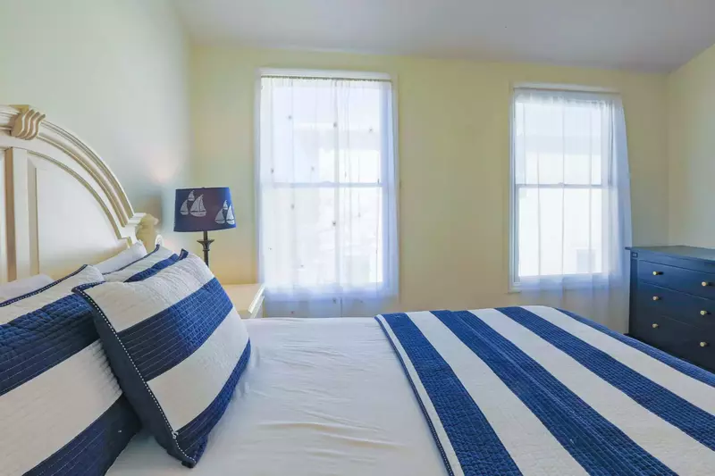 This guest bedroom is located near the kitchen and looks out onto the back side of the building.