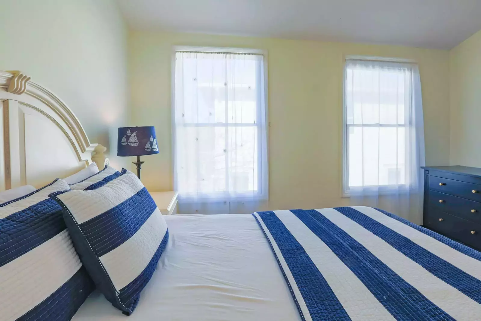 This guest bedroom is located near the kitchen and looks out onto the back side of the building.