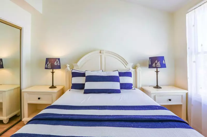 This guest bedroom also has a closet with mirrored doors.