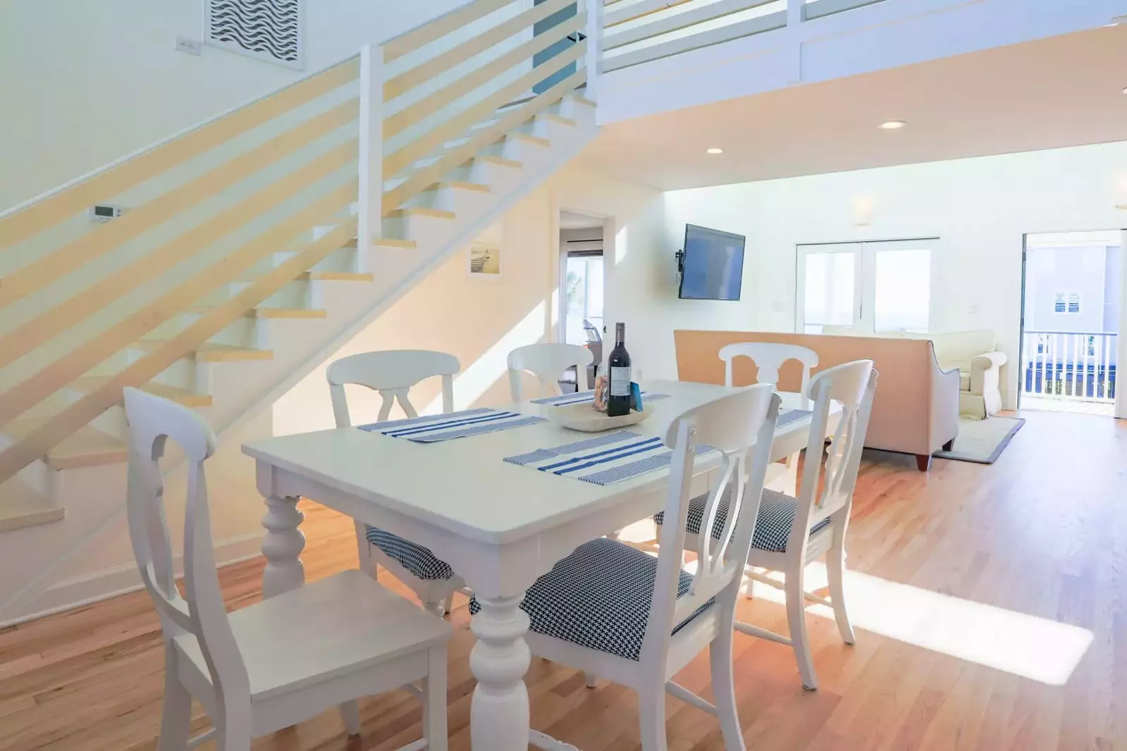 The stairs near the dining table lead to the two upstairs bedrooms.