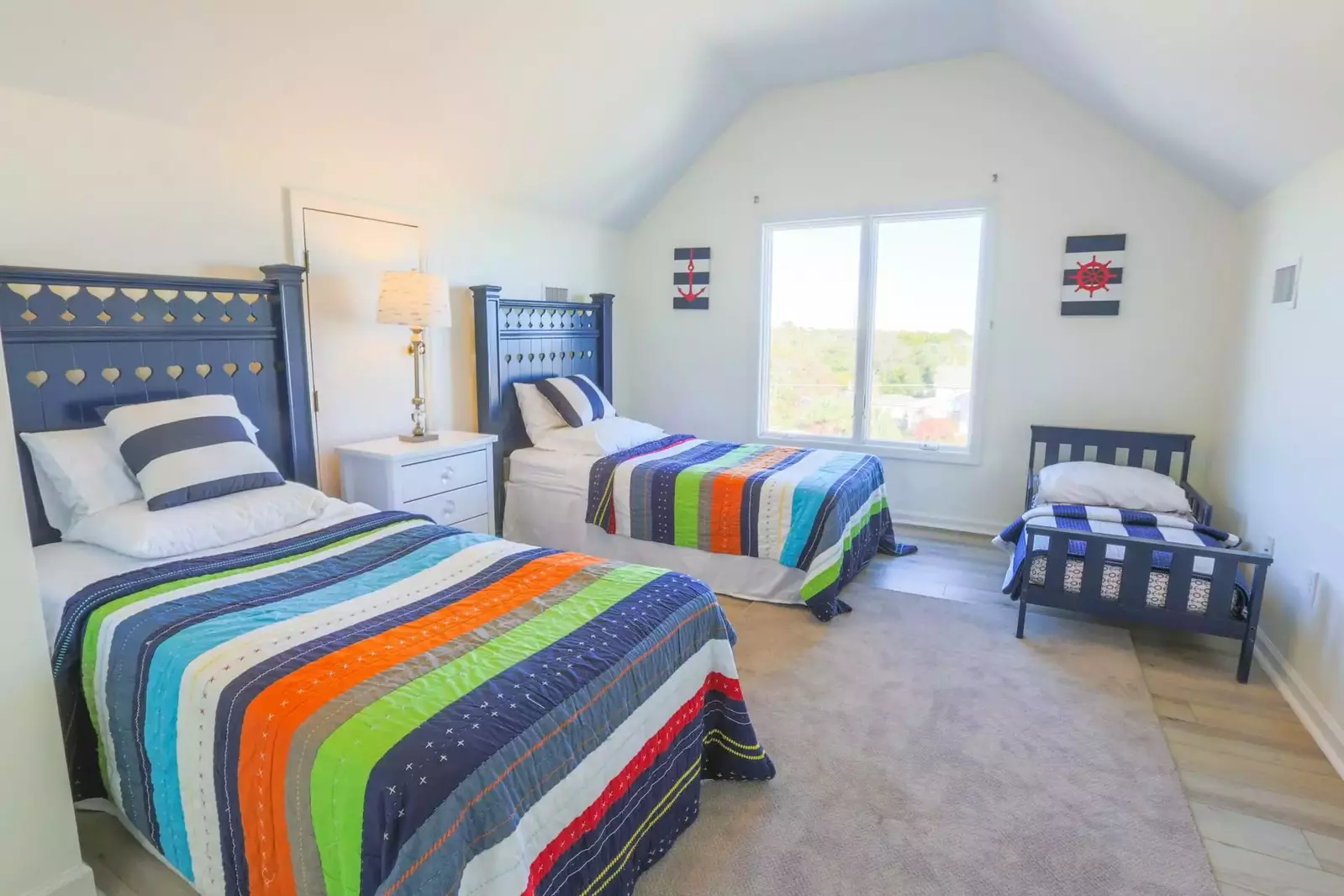 This loft room features two twin beds and a toddler's twin bed.