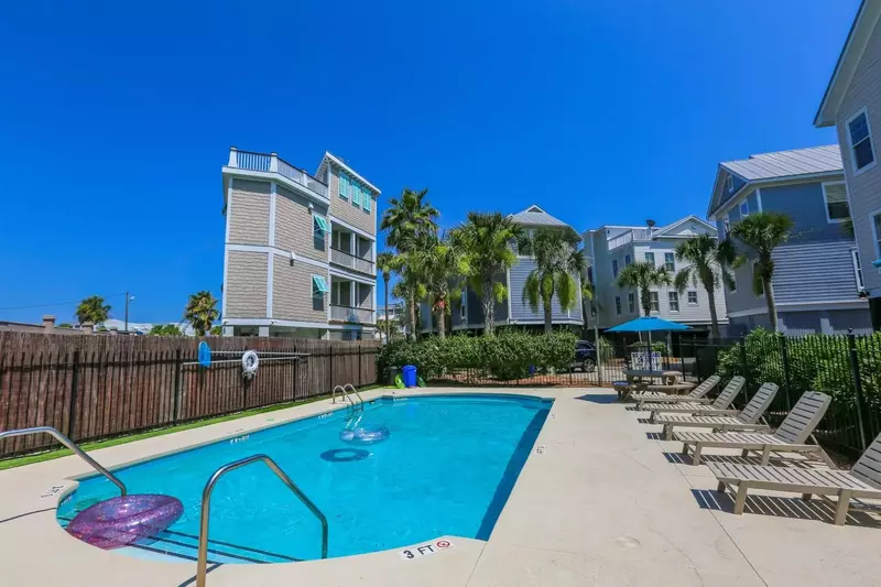 The community pool has a sundeck with lounge chairs.