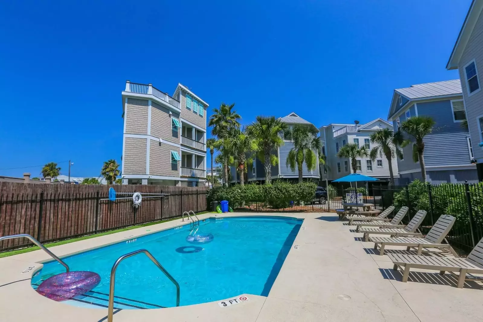 The community pool has a sundeck with lounge chairs.