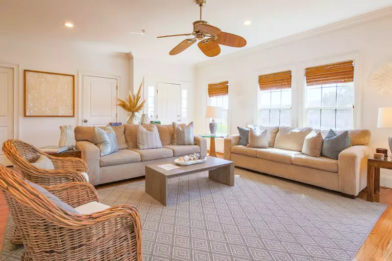 The living room features two sofas, two arm chairs, a coffee table and several end tables.