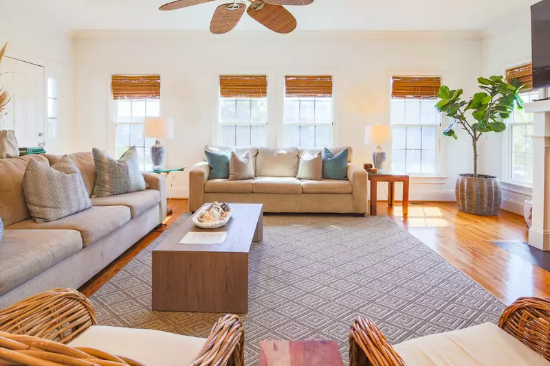 The living room receives wonderful natural light through its many windows.