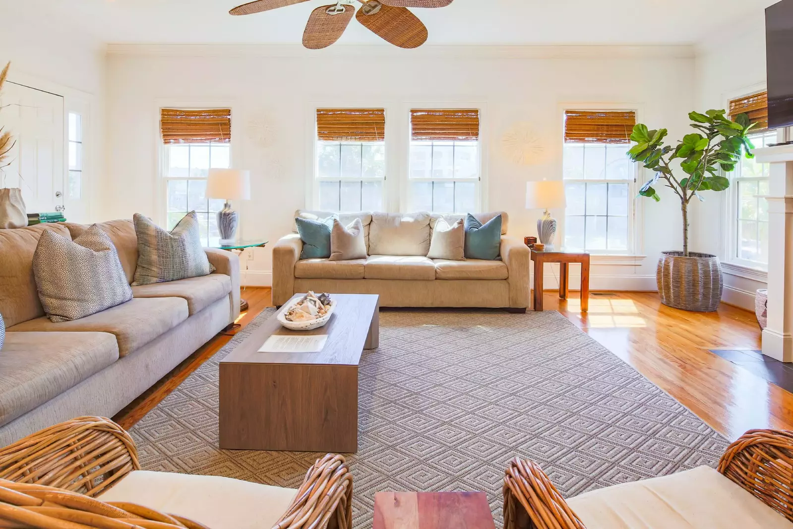 The living room receives wonderful natural light through its many windows.