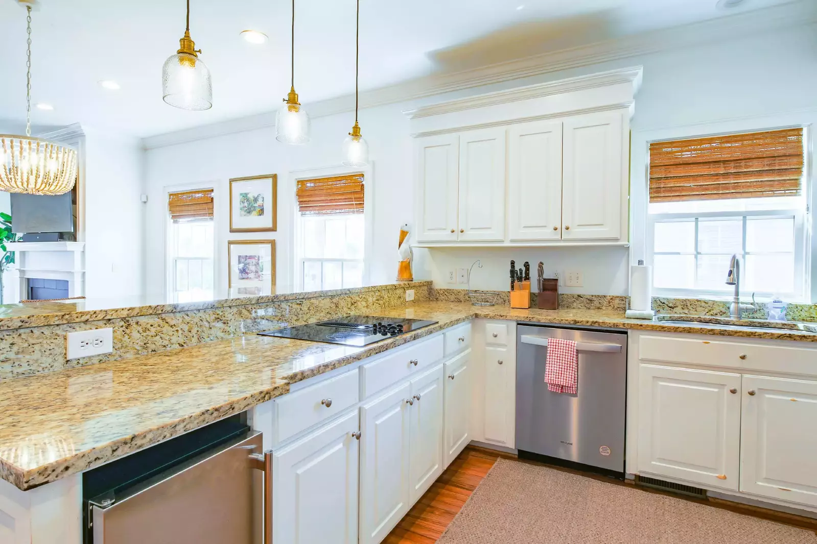 The kitchen features white cabinetry, granite countertops and stainless steel appliances.