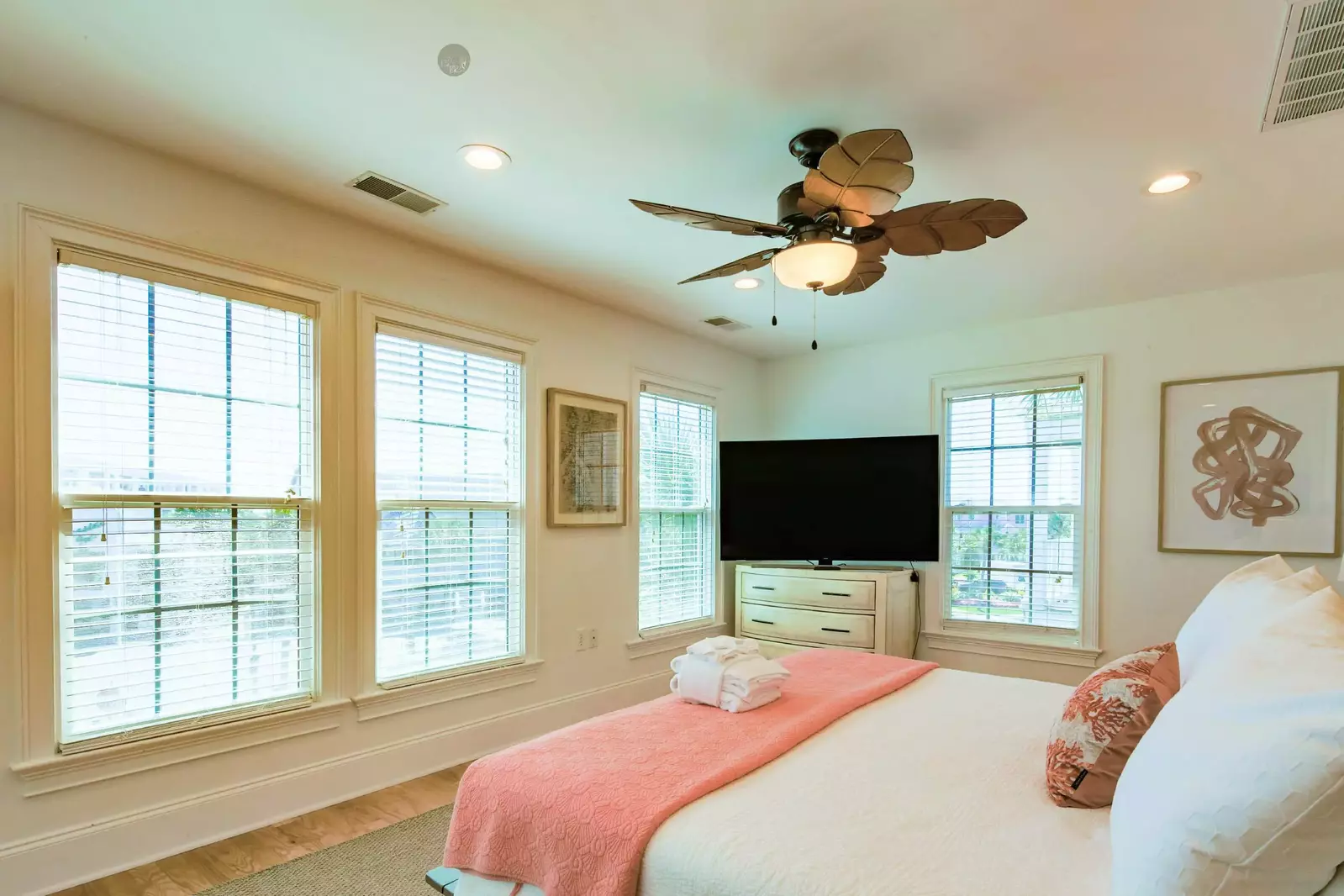 The master suite also features a dresser with large screen smart TV.