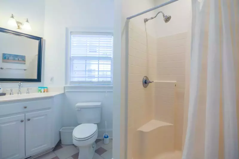 The first floor Jack & Jill bathroom features a spacious vanity and a walk-in shower.