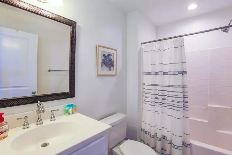 This en suite bathroom features a spacious vanity and a shower/tub combo.