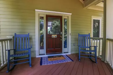 You will be welcomed to the covered front porch by these two rocking chairs.