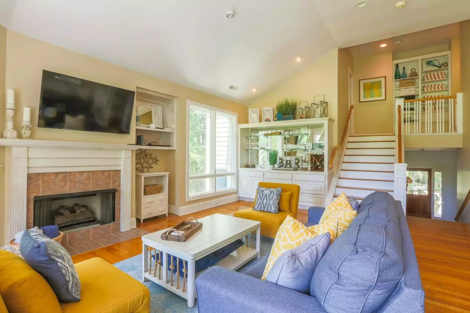 From the foyer, you'll walk up a half flight of stairs to find this comfortable living room.