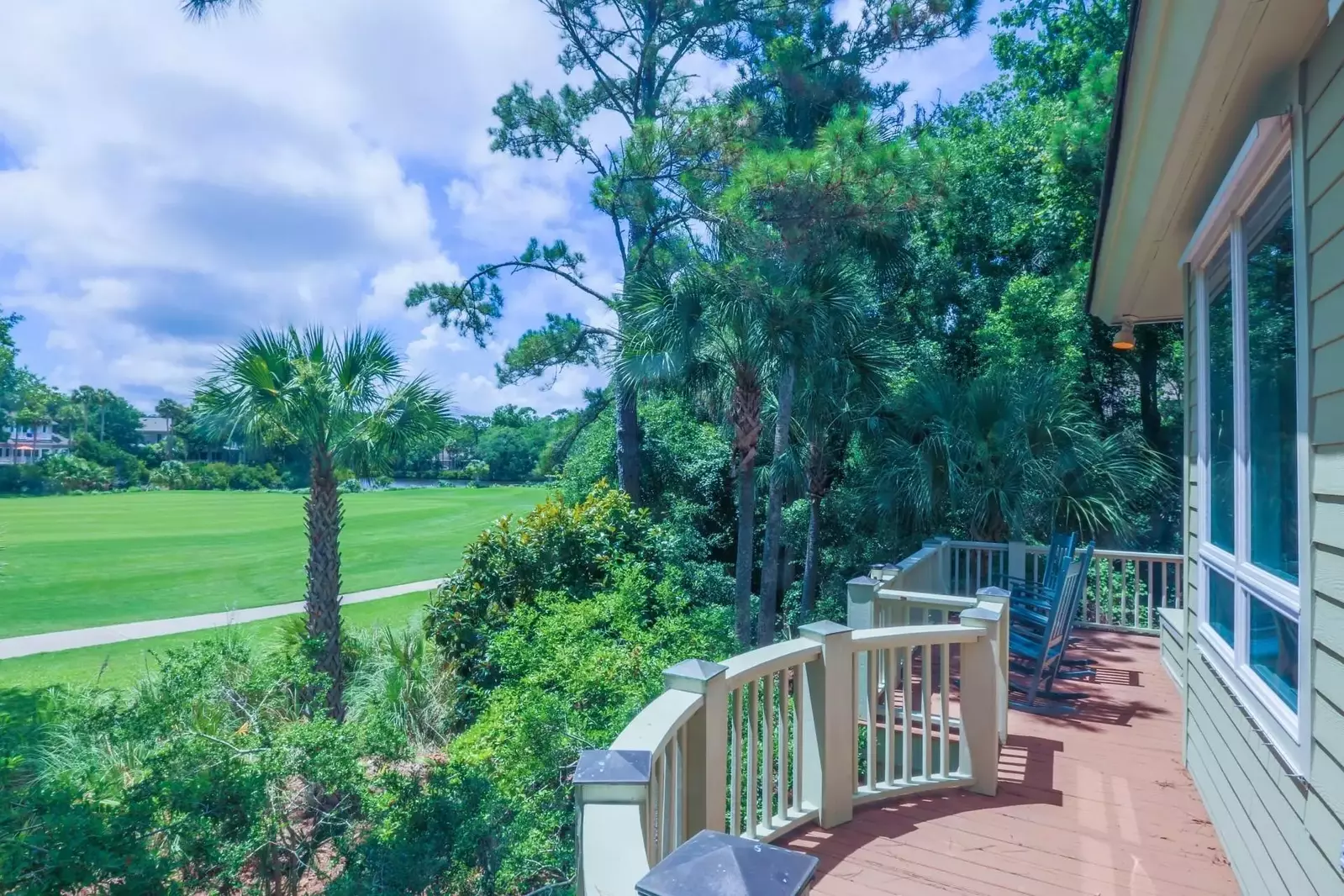 The back porch looks out onto the Palmetto tree lined fairway.