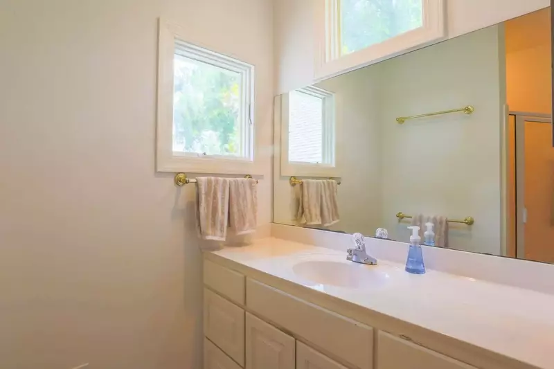 The master bathroom has a spacious vanity with plenty of storage & counter space.