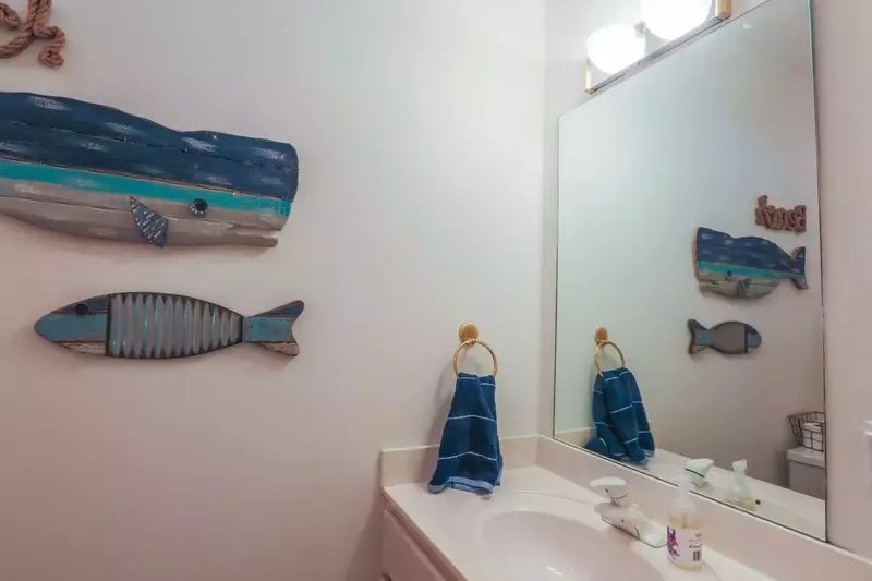 This bathroom features a vanity and a fun fish theme.