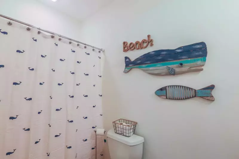 This fish themed bathroom also has a shower.