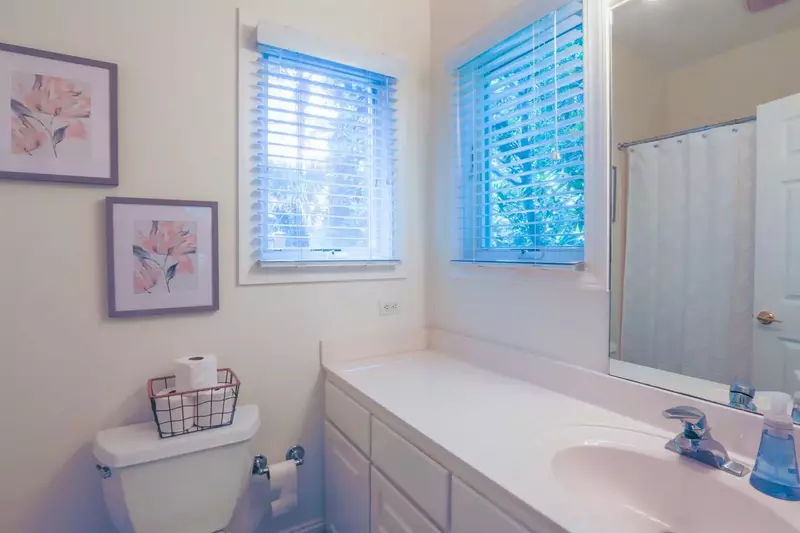 The en suite bathroom has a spacious vanity and shower.