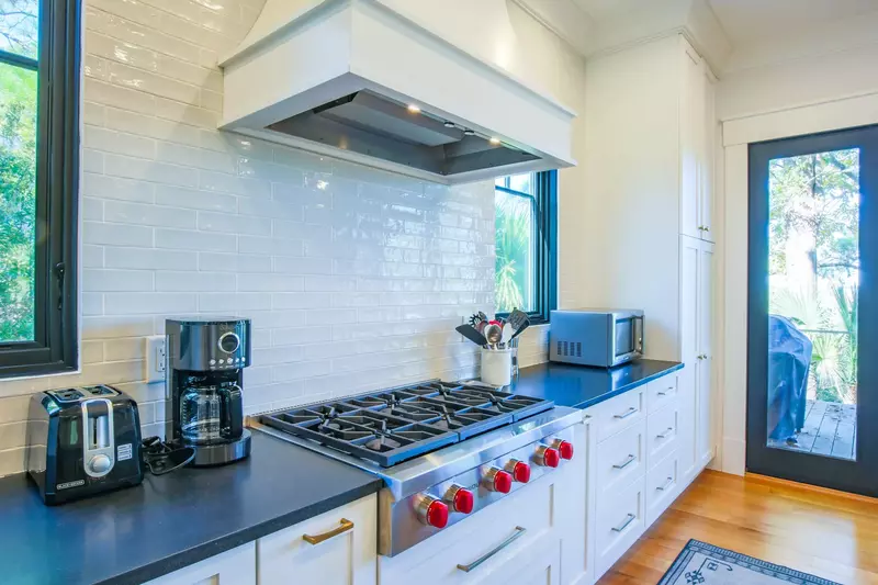 The kitchen has a Wolf gas-burning cooktop, coffee maker, microwave, toaster oven and more.