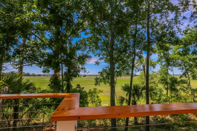 Watch the marsh grasses sway, birds soar and the sun set over this mesmerizing view.