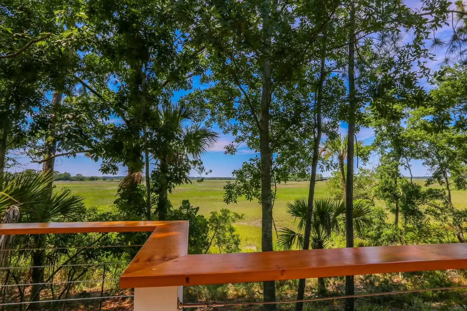 Watch the marsh grasses sway, birds soar and the sun set over this mesmerizing view.