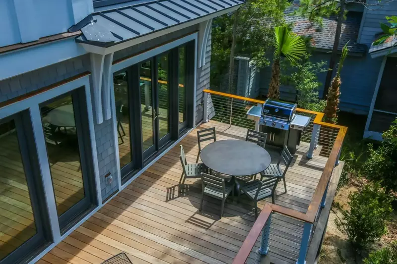 The back deck features a dining table that seats 6 and and propane BBQ grill.