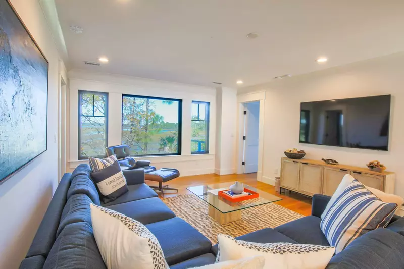 The family room also features beautiful views of the marsh and a large screen TV.