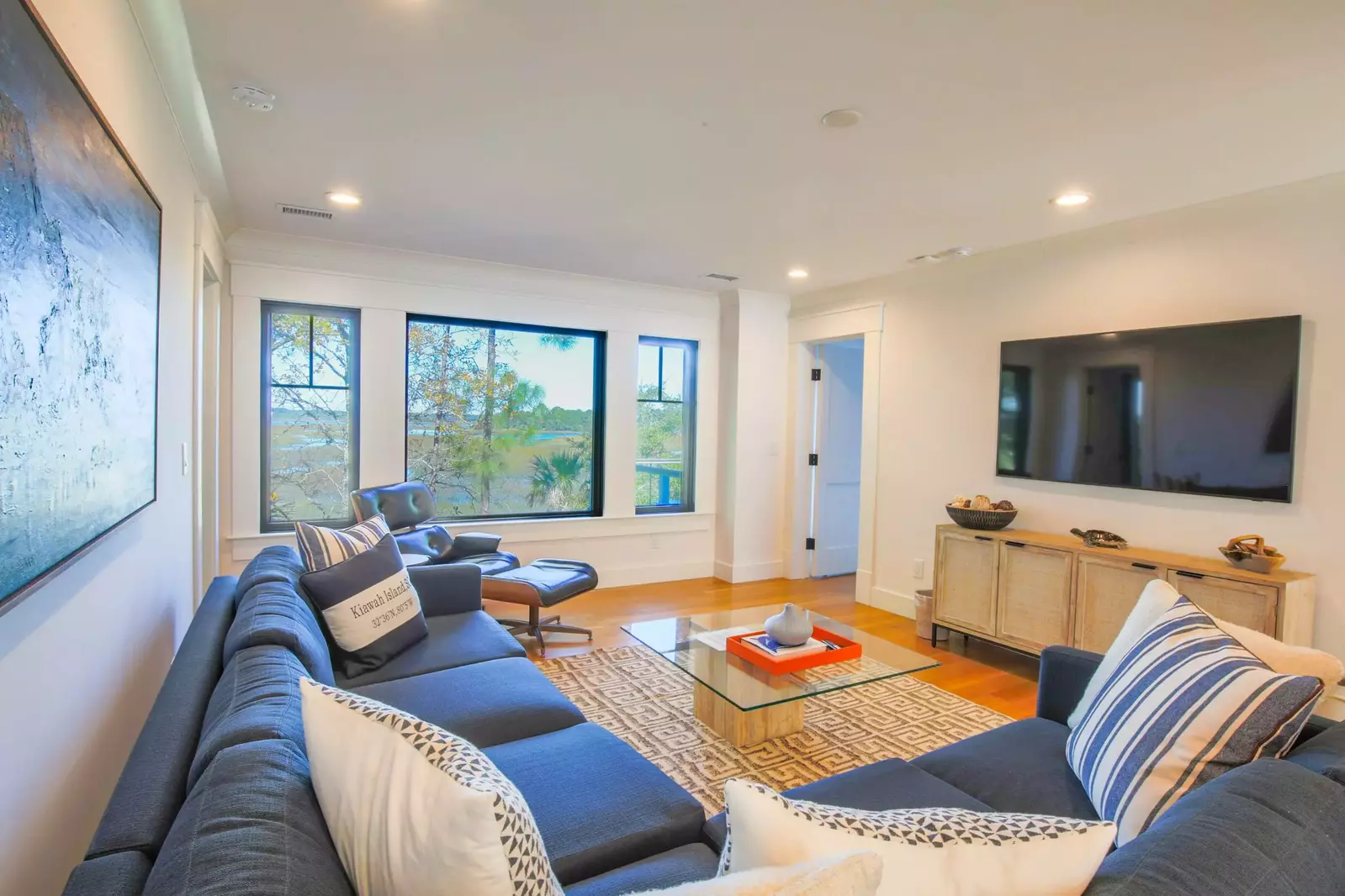 The family room also features beautiful views of the marsh and a large screen TV.