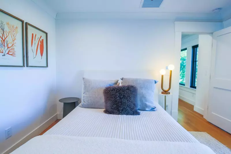 This guest bedroom features a queen bed and nightstands.
