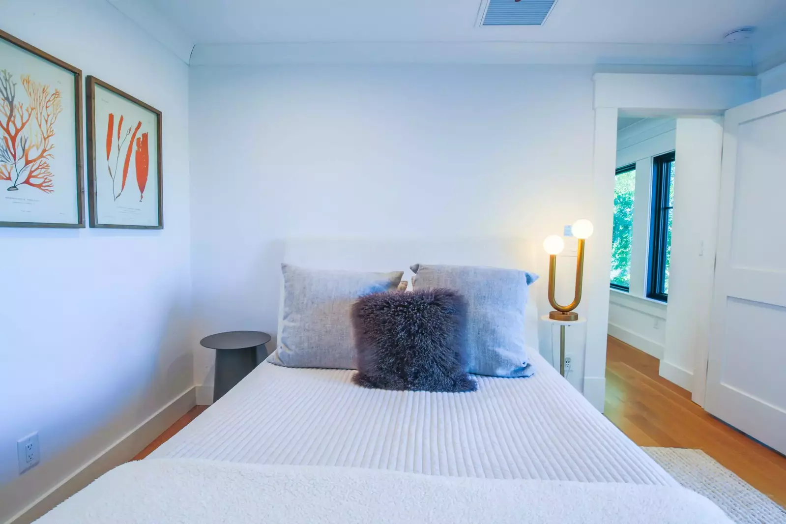 This guest bedroom features a queen bed and nightstands.