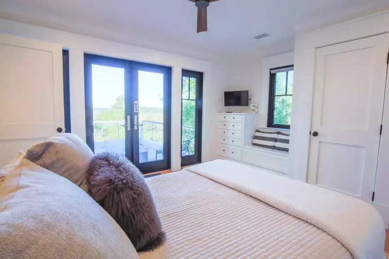 This guest bedroom also has a ceiling fan, streaming TV and access to the upper deck.
