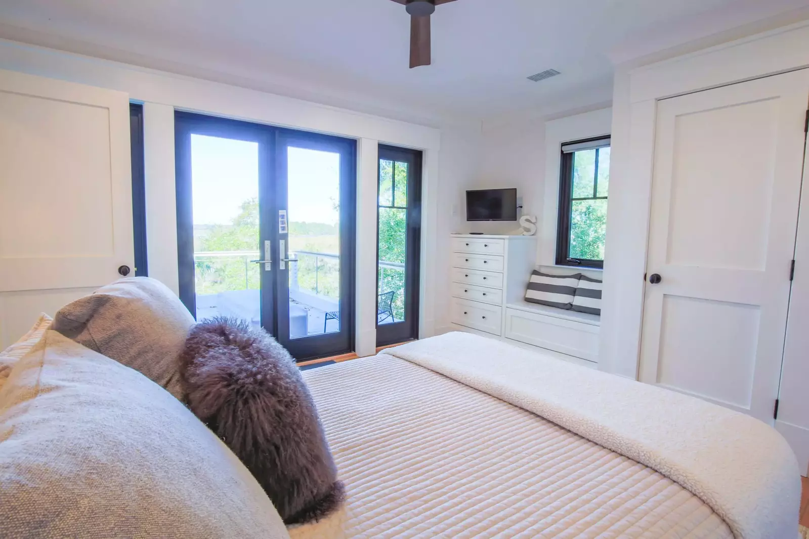 This guest bedroom also has a ceiling fan, streaming TV and access to the upper deck.