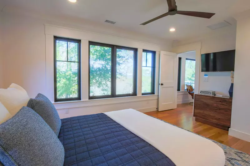 This guest bedroom features a ceiling fan, streaming TV and stunning views of the marsh.