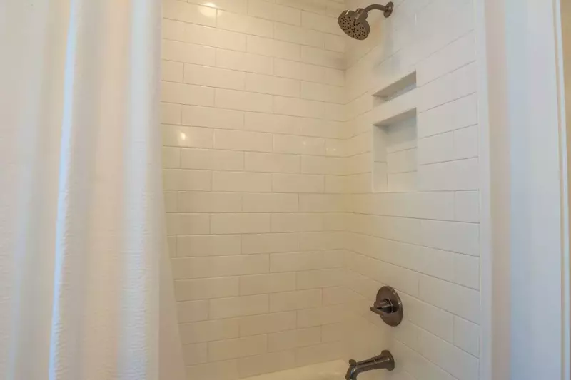 This en suite bathroom has a tiled shower/tub combo.