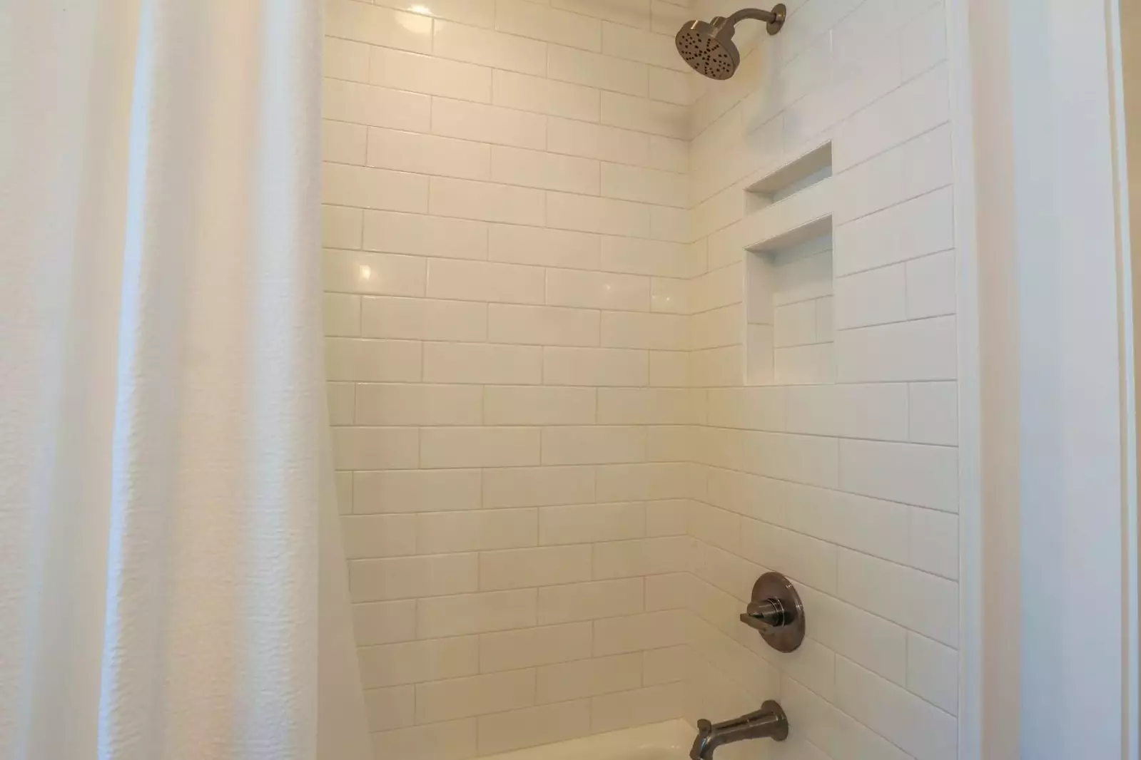 This en suite bathroom has a tiled shower/tub combo.