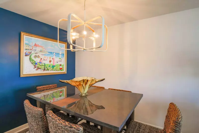 The dining table is located near the entryway and living room.