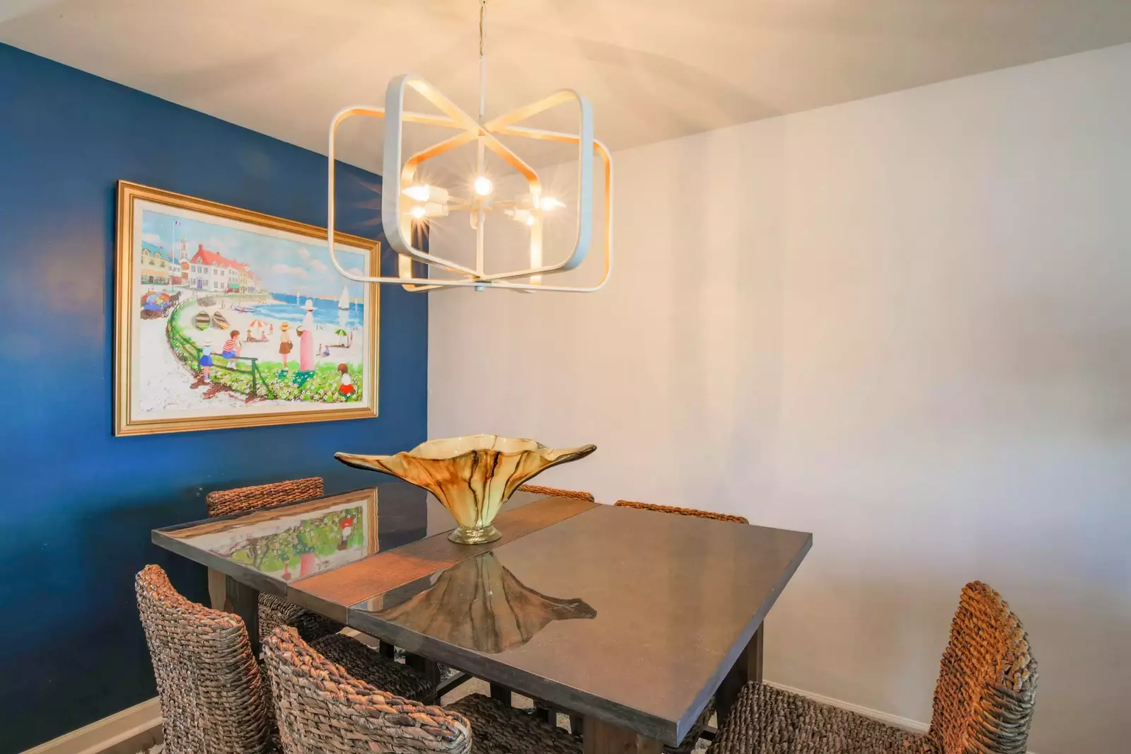 The dining table is located near the entryway and living room.