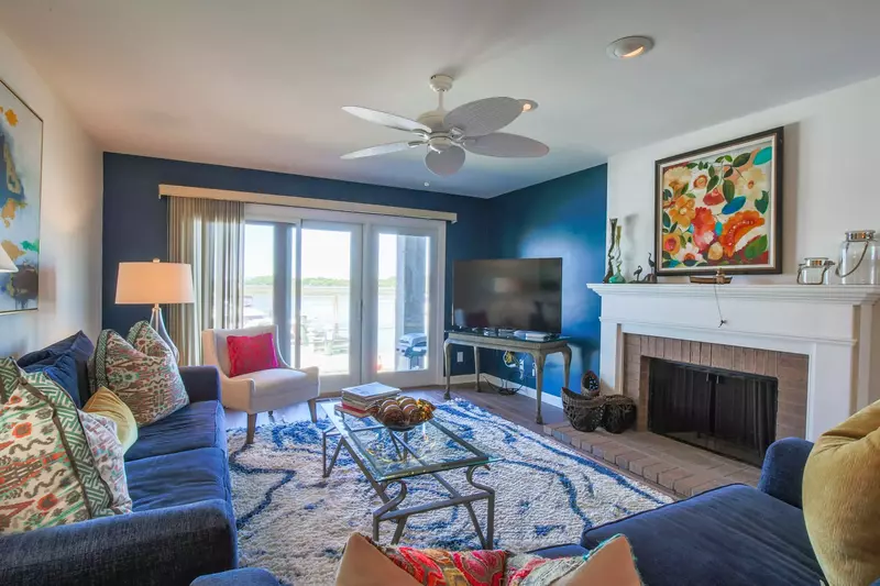 The sliding glass doors in the living room look out onto the Bohicket River and marina.