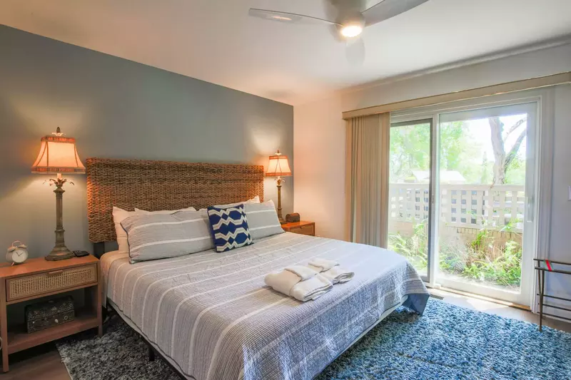 The bedroom features a king bed and night stands with reading lamps.