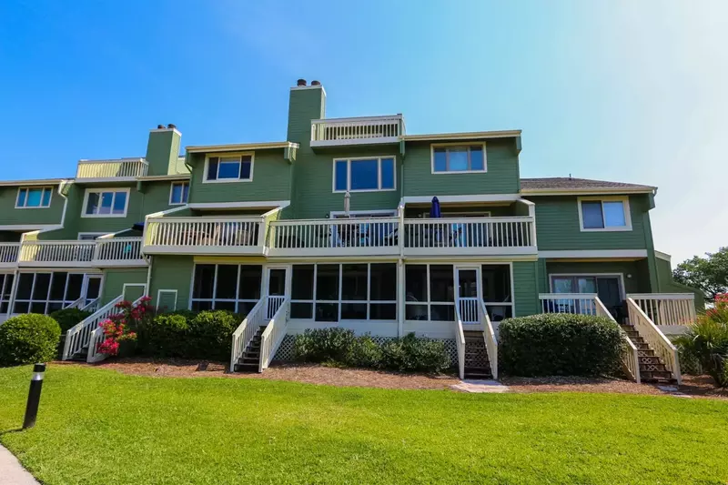 Follow the second set of stairs from the right to enter the screened porch of Walking on Sunshine.