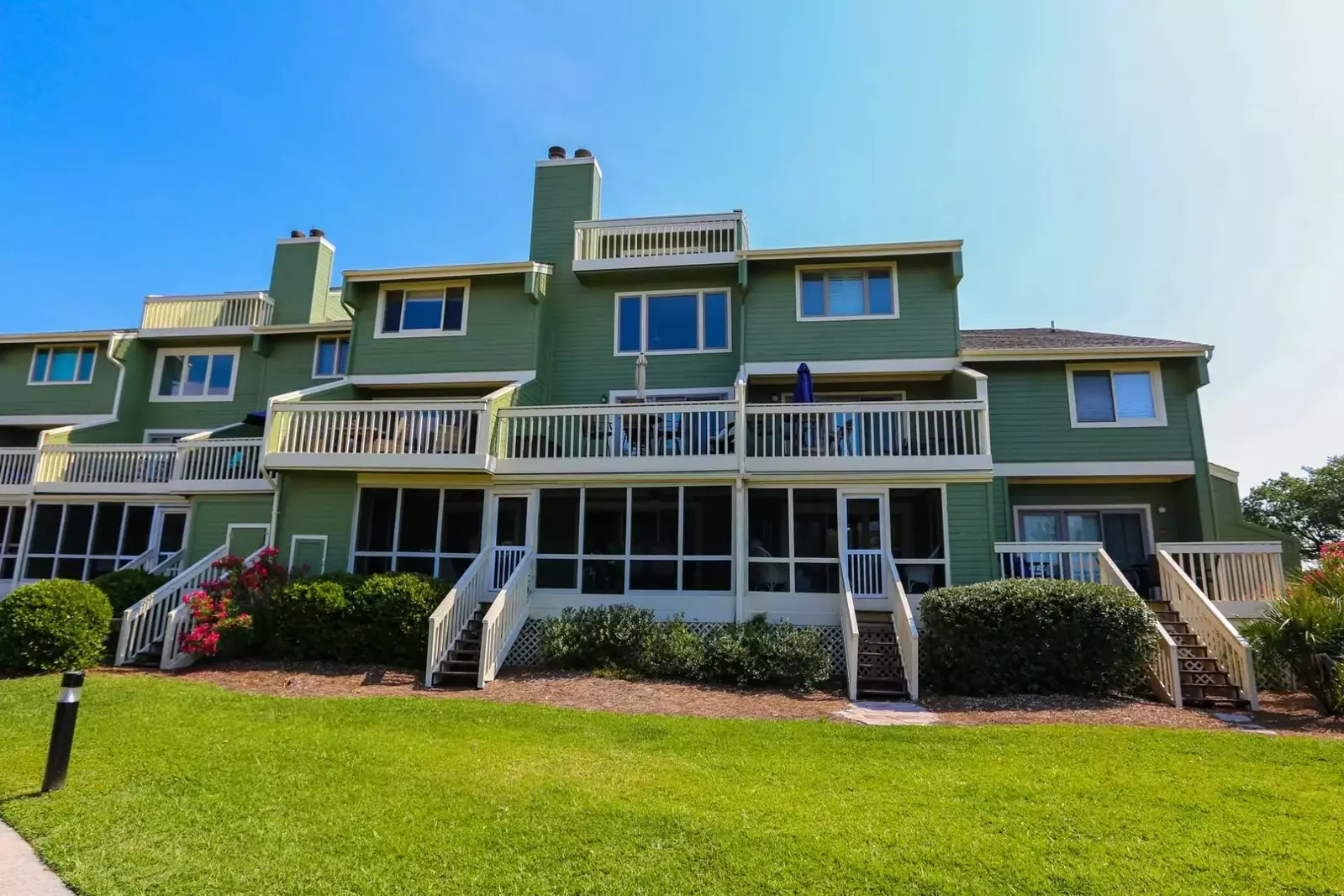 Follow the second set of stairs from the right to enter the screened porch of Walking on Sunshine.