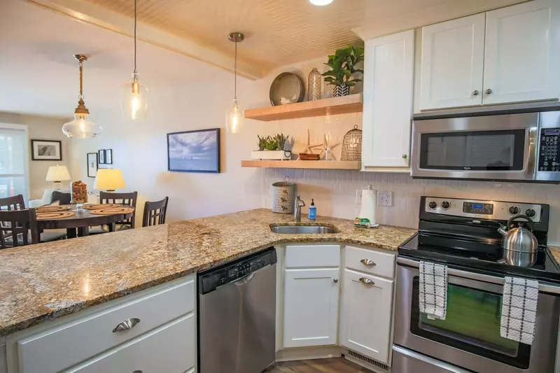 When you enter the home's front door, you'll find an open floor plan layout between the kitchen, dining & living rooms.